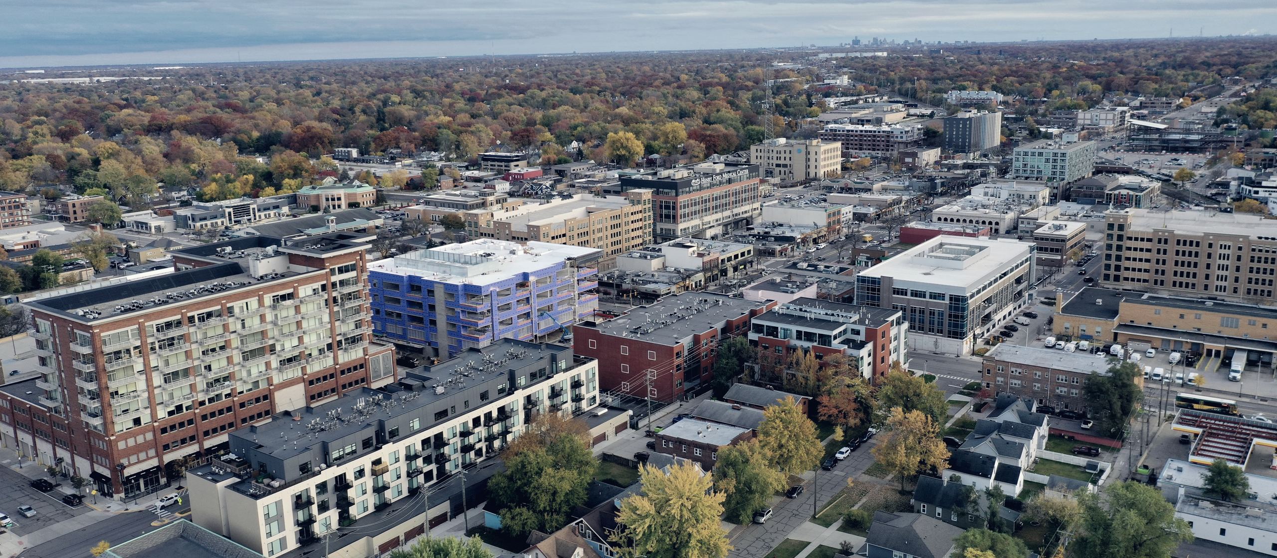 A Metro Detroit suburb from the air in autumn — shops, streets and houses together.